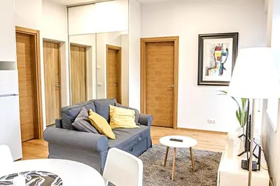 a living room with a blue couch and a table at Modern 1BD Apartment in Old Town by Hostlovers in Kaunas