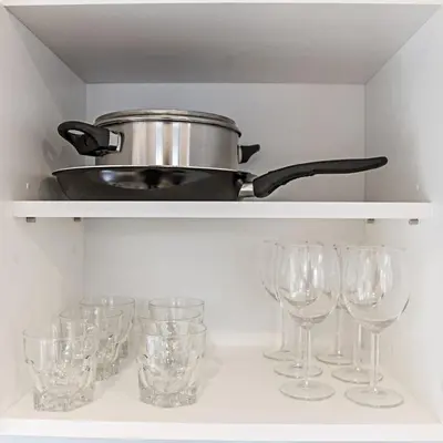 a pot on a shelf with wine glasses at Modern 1BD Apartment in Old Town by Hostlovers in Kaunas