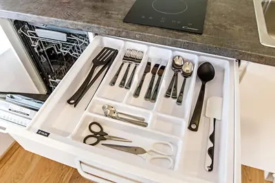a drawer full of kitchen utensils in a drawer at Modern 1BD Apartment in Old Town by Hostlovers in Kaunas