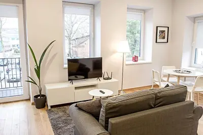a living room with a couch and a tv at Modern 1BD Apartment in Old Town by Hostlovers in Kaunas