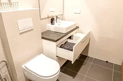a bathroom with a white toilet and a sink at Modern 1BD Apartment in Old Town by Hostlovers in Kaunas