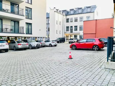 a group of cars parked in a parking lot at Modern 1BD Apartment in Old Town by Hostlovers in Kaunas