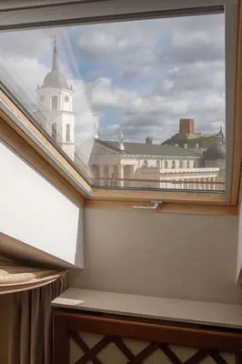 a window in a room with a view of a building at Grand Hotel Vilnius, Curio Collection by Hilton in Vilnius