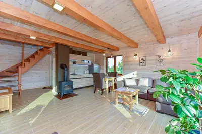 a living room with a couch and a table at Vip Forest dreams villa in Anykščiai