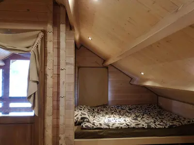 a room with a bed in a wooden cabin at Holiday House & Sauna in Druskininkai in Neravai