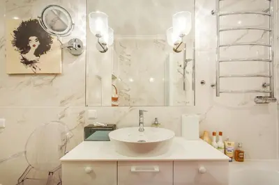 a white bathroom with a sink and a mirror at Luxury, comfort & quiet place next to Cathedral in Vilnius