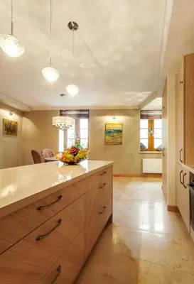 a kitchen with wooden cabinets and a counter top at Luxury, comfort & quiet place next to Cathedral in Vilnius