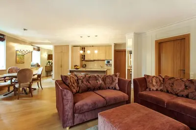 a living room with two couches and a dining room at Luxury, comfort & quiet place next to Cathedral in Vilnius