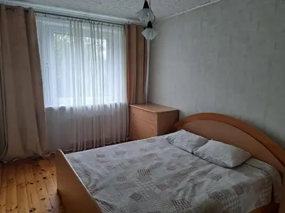 a bedroom with a bed in front of a window at Welcoming apartment in Anykščiai