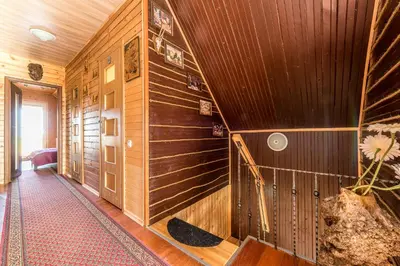 a hallway with wood paneling in a house at Edmart in Dobromislė