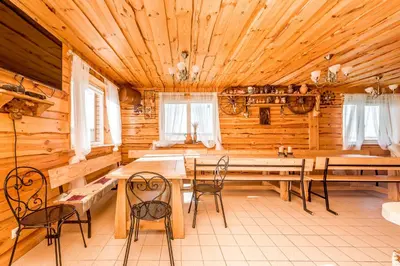 a dining room with tables and chairs in a cabin at Edmart in Dobromislė