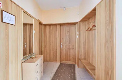 a hallway with wooden walls and a wooden door at Kurpių gatvė in Kaunas