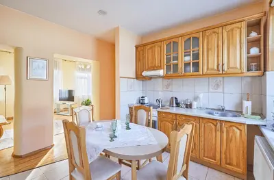 a kitchen with a table and chairs in a room at Kurpių gatvė in Kaunas
