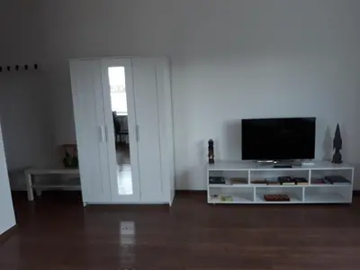 a living room with a television on a white entertainment center at Tilžės gatvė 144 in Šiauliai