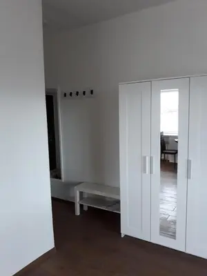 a living room with a white cabinet and a couch at Tilžės gatvė 144 in Šiauliai