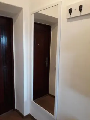 a mirror in the corner of a room at Tilžės gatvė 144 in Šiauliai