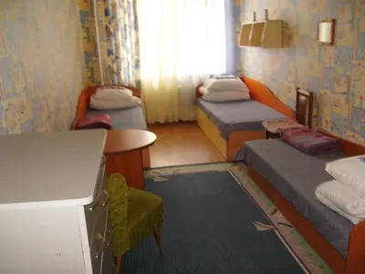 a small room with two beds and a table at Apgyvendinimo įstaiga KORNEALITA-ZARASAI in Zarasai