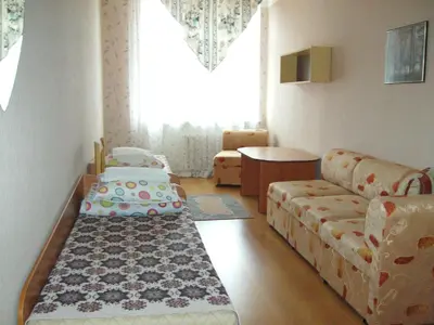 a living room with a couch and a table and a couch at Apgyvendinimo įstaiga KORNEALITA-ZARASAI in Zarasai