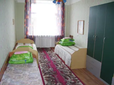a small bedroom with two beds and a window at Apgyvendinimo įstaiga KORNEALITA-ZARASAI in Zarasai