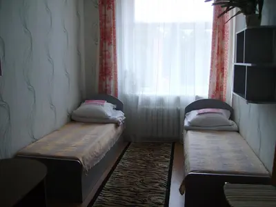 two beds in a small room with a window at Apgyvendinimo įstaiga KORNEALITA-ZARASAI in Zarasai