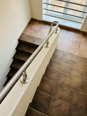 a staircase with metal railings and a tile floor at Apgyvendinimo įstaiga KORNEALITA-ZARASAI in Zarasai