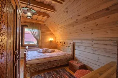 a bedroom with a bed in a log cabin at Sodyba 