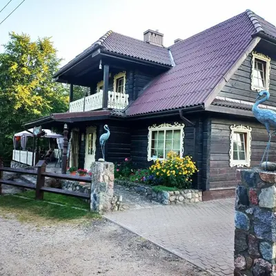 a large wooden house with a roof at Sodyba 