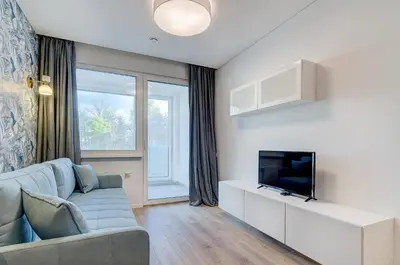 a living room with a couch and a tv at City Studio 1B in a great location in Vilnius