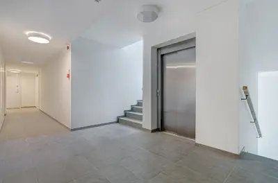a hallway with a door and stairs in a building at City Studio 1B in a great location in Vilnius