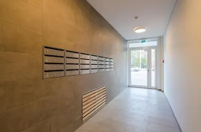a hallway with a wall with empty wine racks at City Studio 1B in a great location in Vilnius