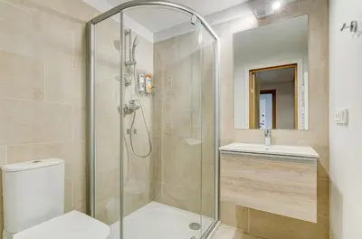 a bathroom with a shower and a toilet and a sink at City Studio 1B in a great location in Vilnius