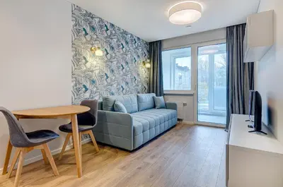 a living room with a couch and a table at City Studio 1B in a great location in Vilnius