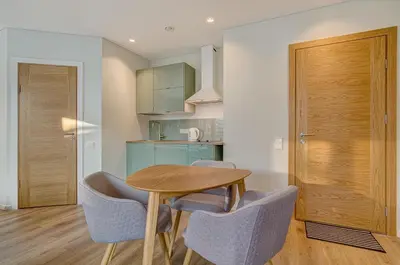 a dining room with a wooden table and chairs at City Studio 1A - Courtyard View in Vilnius