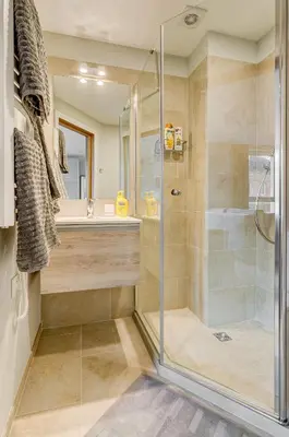a bathroom with a glass shower and a sink at City Studio 1A - Courtyard View in Vilnius