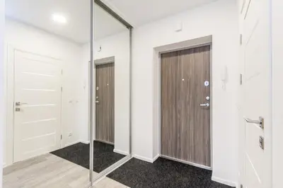 a walk in closet with white walls and a glass door at Apartments Vilnius 1 near center with a roof terrace and parking in Vilnius