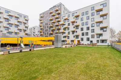 a park in front of a building with a playground at Apartments Vilnius 1 near center with a roof terrace and parking in Vilnius