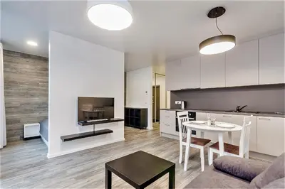 a kitchen and a living room with a table and a couch at Apartments Vilnius 1 near center with a roof terrace and parking in Vilnius