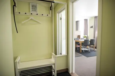 an office hallway with a door leading to a dining room at Eliksyras Apartment in Vilnius