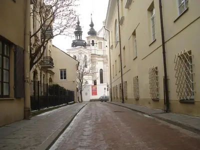 an empty street in a city with a building at Eliksyras Apartment in Vilnius