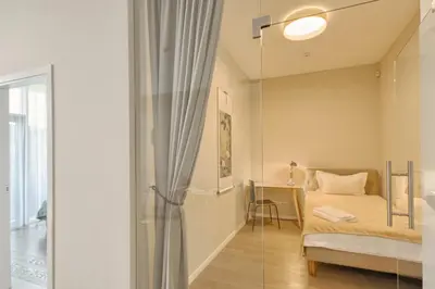 a bedroom with a bed and a glass wall at Asian Magnolia Boutique Apartments in Druskininkai