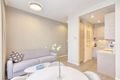 a living room with a couch and a table at Asian Magnolia Boutique Apartments in Druskininkai