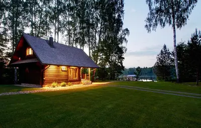 a small cabin in a field of green grass at Prie Klykio in Utena