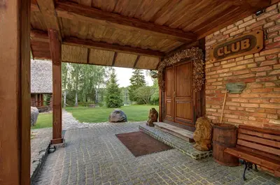 an entrance to a building with a wooden door at Prie Klykio in Utena