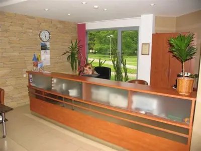 a woman sitting in a chair in a waiting room at Hotel Ode Self Check-In in Alytus