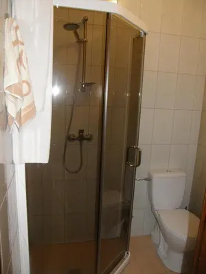 a bathroom with a shower and a toilet at Hotel Ode Self Check-In in Alytus