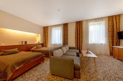 a hotel room with two beds and a couch at Pažaislis Park Hotel in Kaunas