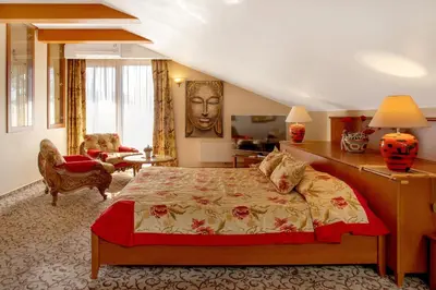 a bedroom with a bed and a living room at Pažaislis Park Hotel in Kaunas