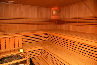 an empty sauna with wooden benches in a room at Pažaislis Park Hotel in Kaunas