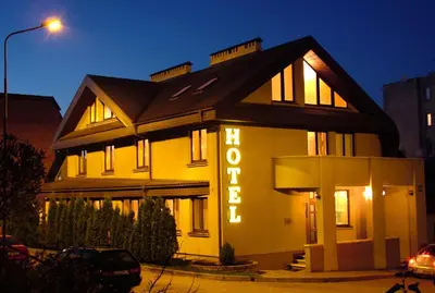 a building with a sign that says hotel at Hotel Senas Namas in Alytus