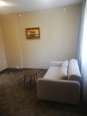a living room with a couch and a table at Hotel Senas Namas in Alytus